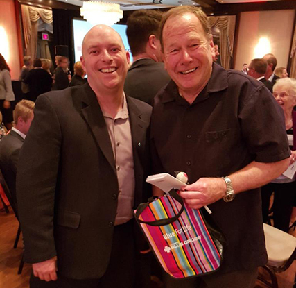 Alberta Blue Cross staff member Nolan (left) and Shepherd’s Care Resident Robert (right) at the Cake Auction